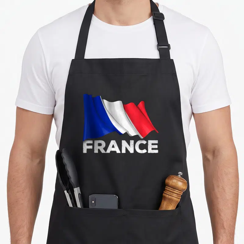 Tablier de cuisine noir avec drapeau français ondulé et inscription FRANCE en blanc texturé.