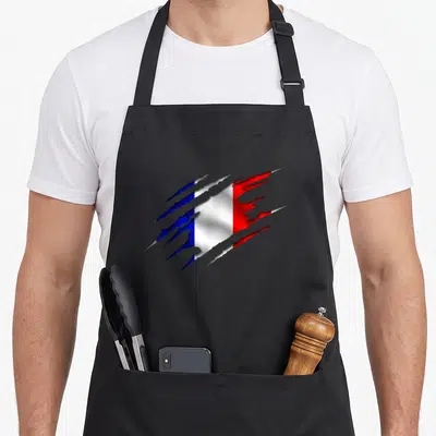 Tablier de cuisine noir avec un drapeau français en effet de déchirure bleue blanche et rouge.