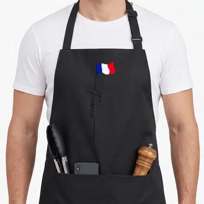 Tablier de cuisine noir avec drapeau français tricolore et inscription France manuscrite verticale noire.