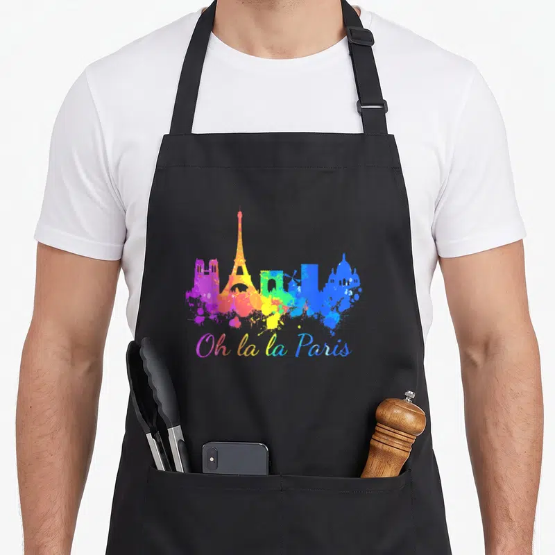 Tablier de cuisine noir avec skyline parisien coloré et inscription Oh la la Paris en lettres arc-en-ciel.