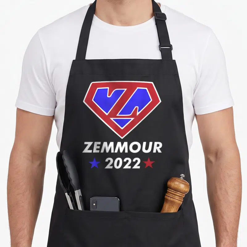 Tablier de cuisine noir avec logo Zemmour 2022 en forme d'emblème de super-héros rouge et bleu.