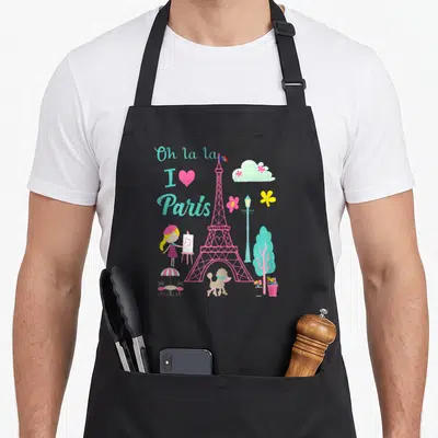 Tablier de cuisine noir avec illustration rose de la Tour Eiffel, une petite fille peintre et un poodle sous le texte Oh la la I love Paris.