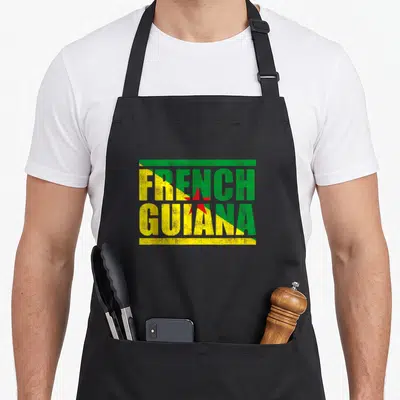Tablier de cuisine noir avec l'inscription French Guiana aux couleurs du drapeau régional et une étoile rouge centrale.