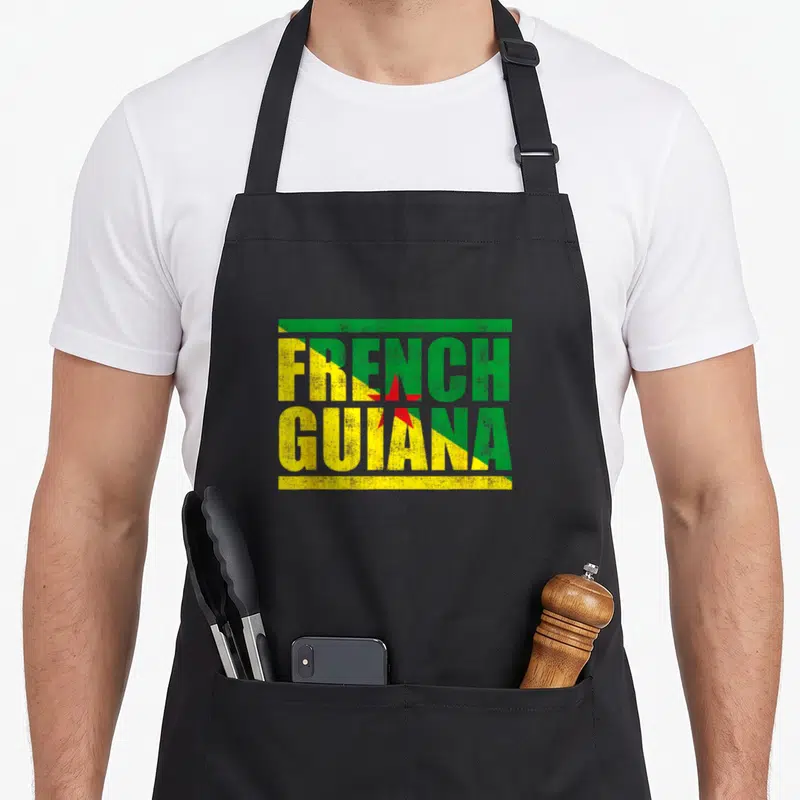 Tablier de cuisine noir avec l'inscription French Guiana aux couleurs du drapeau régional et une étoile rouge centrale.