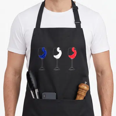 Tablier de cuisine noir avec trois verres à vin aux couleurs bleu blanc et rouge contenant des silhouettes féminines stylisées.