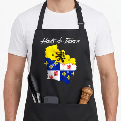 Tablier de cuisine noir avec carte colorée des Hauts-de-France et symboles héraldiques régionaux imprimés au centre.