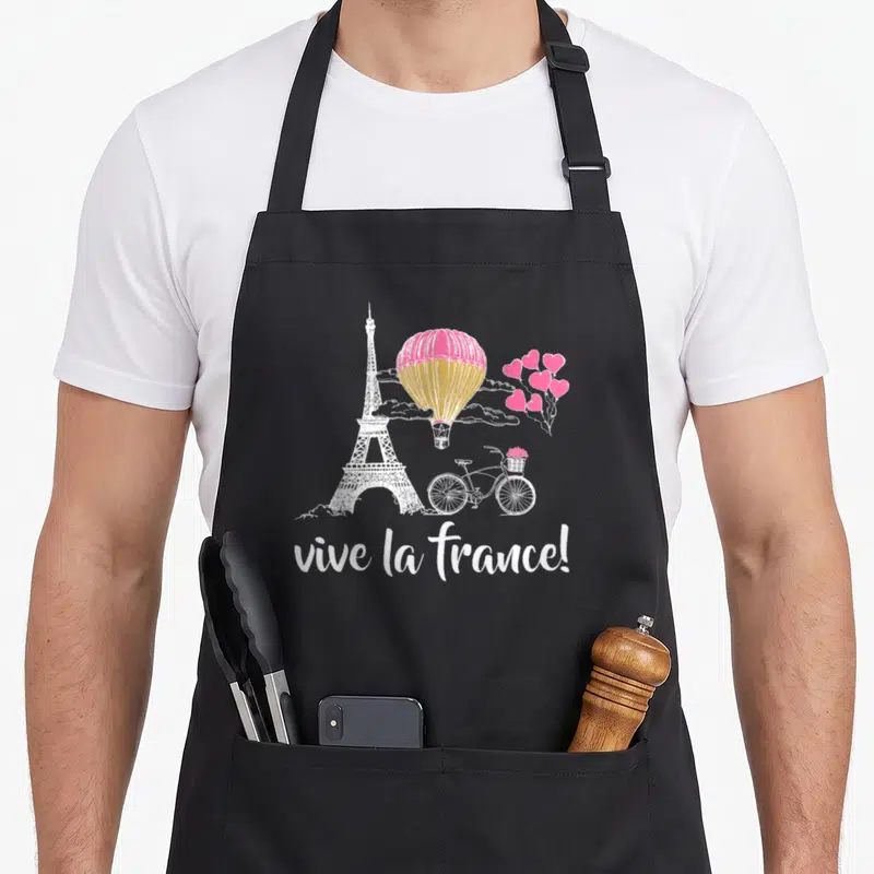 Tablier de cuisine noir avec illustration blanche de la Tour Eiffel, ballon rose et vélo romantique.