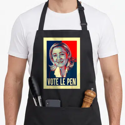 Tablier de cuisine noir avec illustration stylisée de Marine Le Pen et le texte vote le pen en bas.