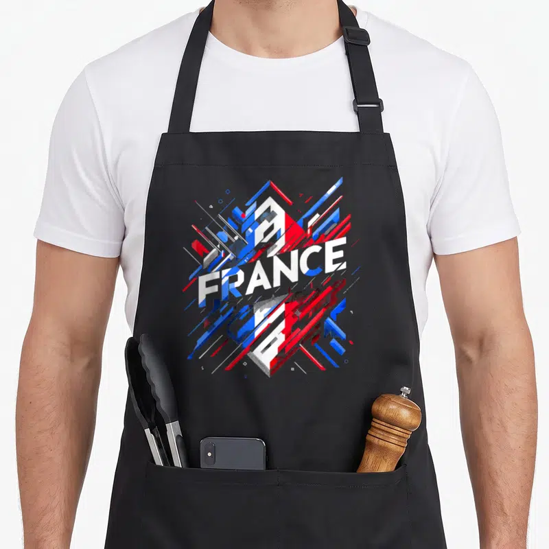 Tablier de cuisine noir avec illustration géométrique aux couleurs du drapeau français et le mot FRANCE au centre.
