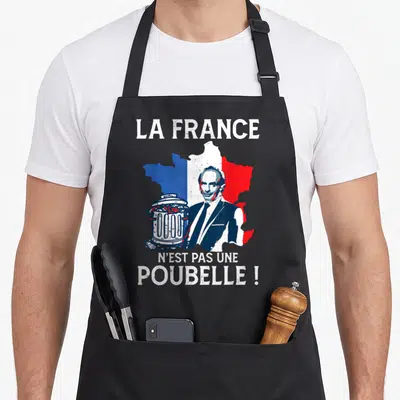 Tablier de cuisine noir avec illustration d'Eric Zemmour, une poubelle et une carte de France aux couleurs du drapeau national.
