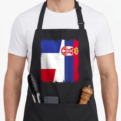 Tablier de cuisine noir avec un demi-drapeau France Serbie stylisé aux couleurs vives et à l'aigle bicéphale.