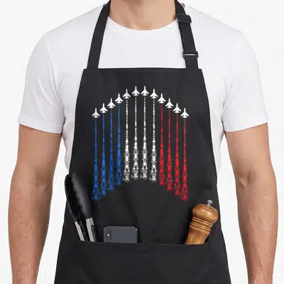Tablier de cuisine noir avec des avions blancs traçant un arc aux couleurs du drapeau français.