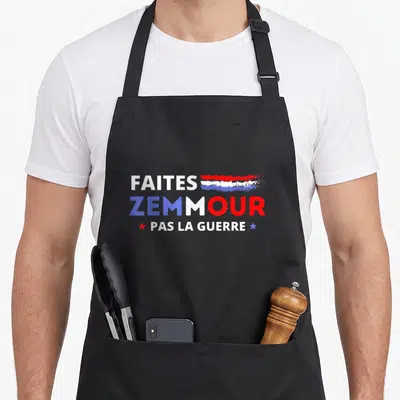 Tablier de cuisine noir avec le texte Faites Zemmour Pas La Guerre en lettres blanches bleues et rouges.