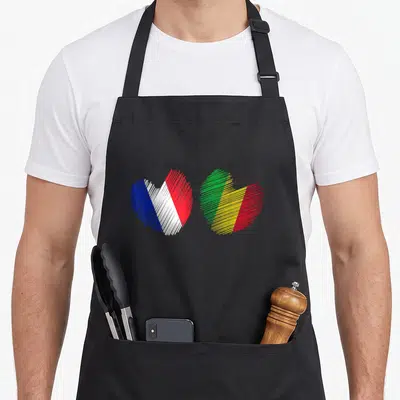 Tablier de cuisine noir avec deux coeurs dessinés aux drapeaux France et Mali en lignes diagonales.