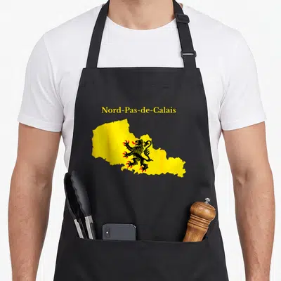Tablier de cuisine noir avec carte jaune du Nord-Pas-de-Calais et lion héraldique noir orné de griffes rouges.