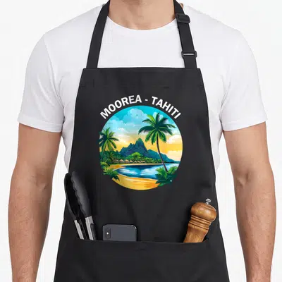Tablier de cuisine noir avec une illustration circulaire représentant Moorea et Tahiti avec des palmiers et une montagne.