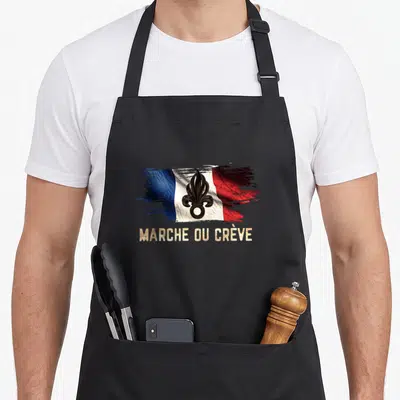 Tablier de cuisine noir avec drapeau français brossé, lis noir et texte Marche ou Crève en lettres dorées texturées.