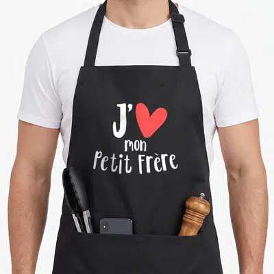 Tablier de cuisine noir avec inscription J'aime mon petit frère et un grand cœur rouge au centre du design imprimé.