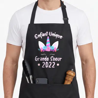 Tablier de cuisine noir avec illustration licorne rose et texte Enfant Unique Grande Soeur 2022