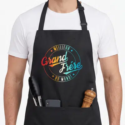 Tablier de cuisine noir avec un logo circulaire multicolore Meilleur Grand Frère du Monde