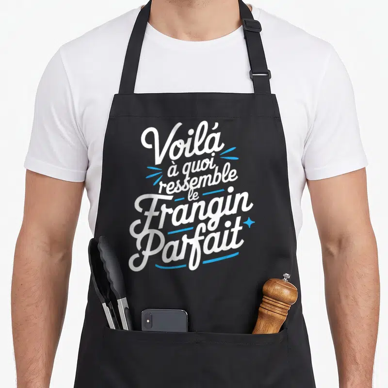 Tablier de cuisine noir avec inscription blanche et accents bleus Voilà à quoi ressemble le Frangin Parfait