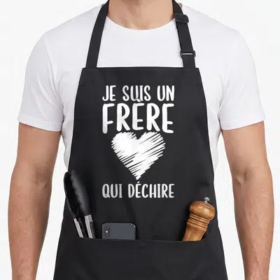 Tablier de cuisine noir avec texte blanc Je suis un frère qui déchire et un cœur esquissé au centre.