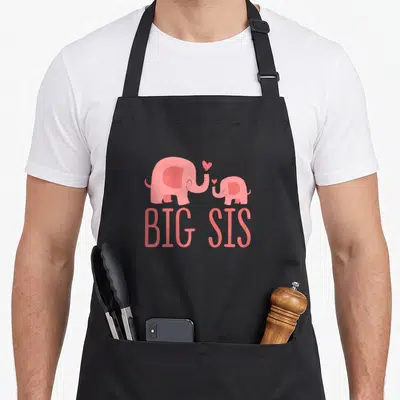 Tablier de cuisine noir avec deux éléphants roses et l'inscription Big Sis en lettres capitales.
