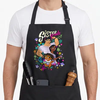 Tablier de cuisine noir avec illustration colorée Mirabel Isabela Luisa Sister Goals et motifs floraux.