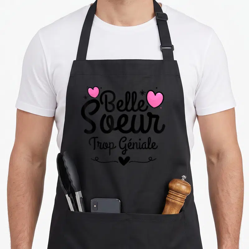 Tablier de cuisine noir avec inscription Belle Soeur Trop Géniale et cœurs roses stylisés.