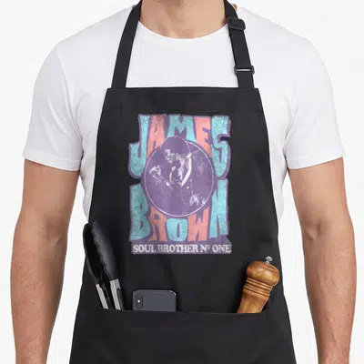 Tablier de cuisine noir avec illustration rétro de James Brown et texte Soul Brother N° One en bleu et rose.