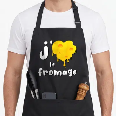 Tablier de cuisine noir avec un cœur de fromage jaune fondu et le texte J'aime le fromage en blanc.