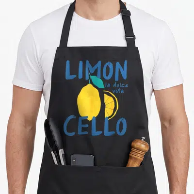 Tablier de cuisine noir avec illustration d'un citron jaune et du texte bleu Limoncello la dolce vita.