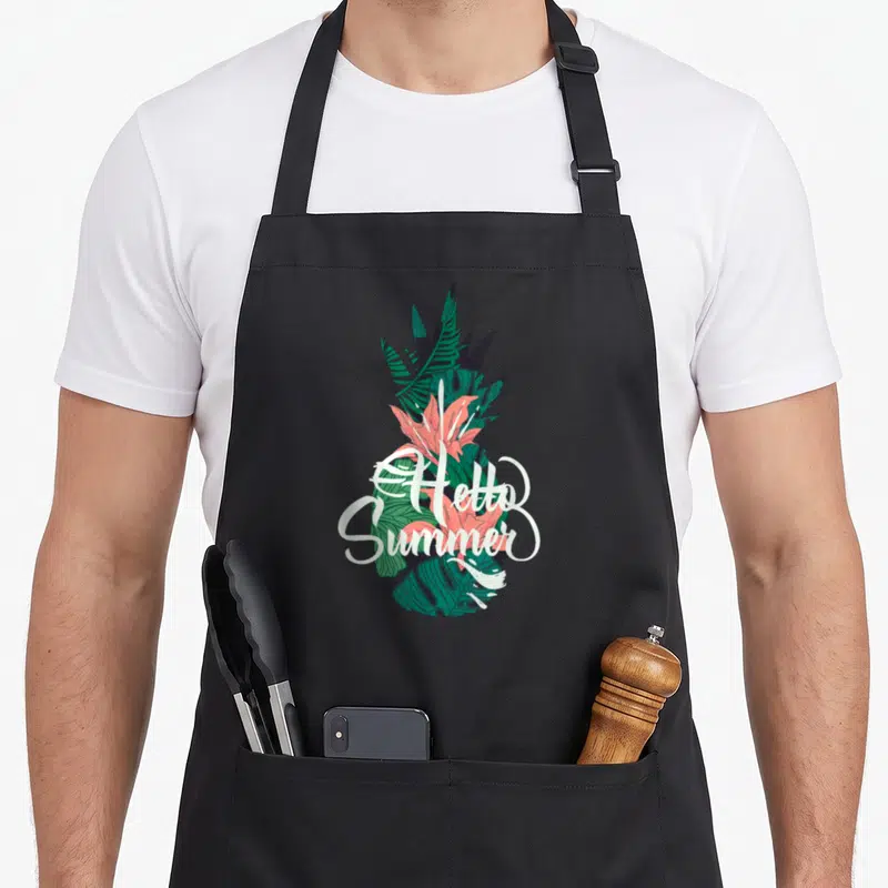 Tablier de cuisine noir avec illustration d'ananas tropical et texte « Hello Summer Beach Ananas Ambiances » en blanc.