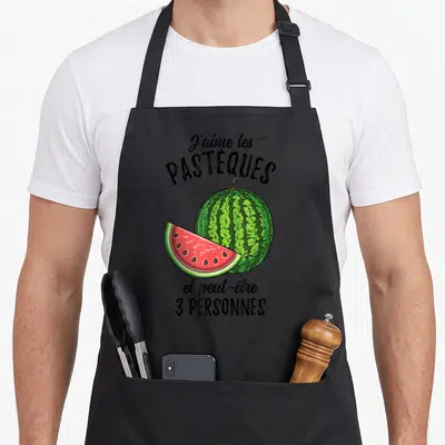 Tablier de cuisine noir avec illustration d'une pastèque entière, d'une tranche rose et texte humoristique en noir.