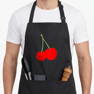 Tablier de cuisine noir avec illustration de deux cerises rouges reliées par des tiges vertes claires