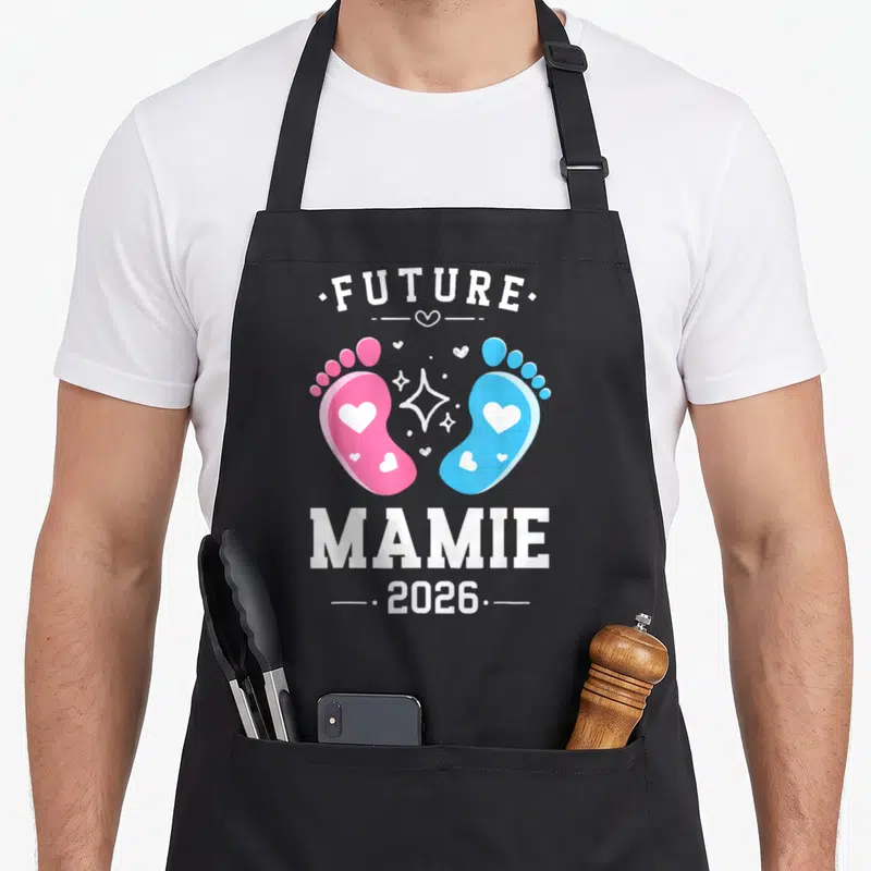 Tablier de cuisine noir avec deux petites empreintes de pieds roses et bleues portant des cœurs blancs au centre.