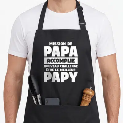 Tablier de cuisine noir avec inscription blanche Mission de Papa Accomplie et challenge Papy.