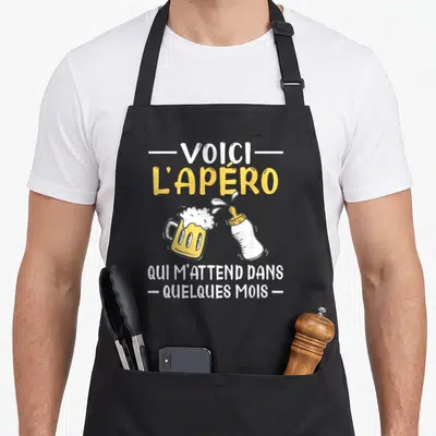 Tablier de cuisine noir avec illustration d'une bière et d'un biberon et texte blanc jaune