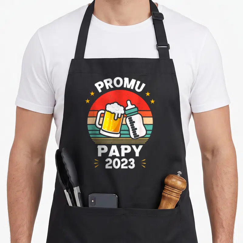 Tablier de cuisine noir avec illustration rétro d'une bière et d'un biberon Promu Papy 2023