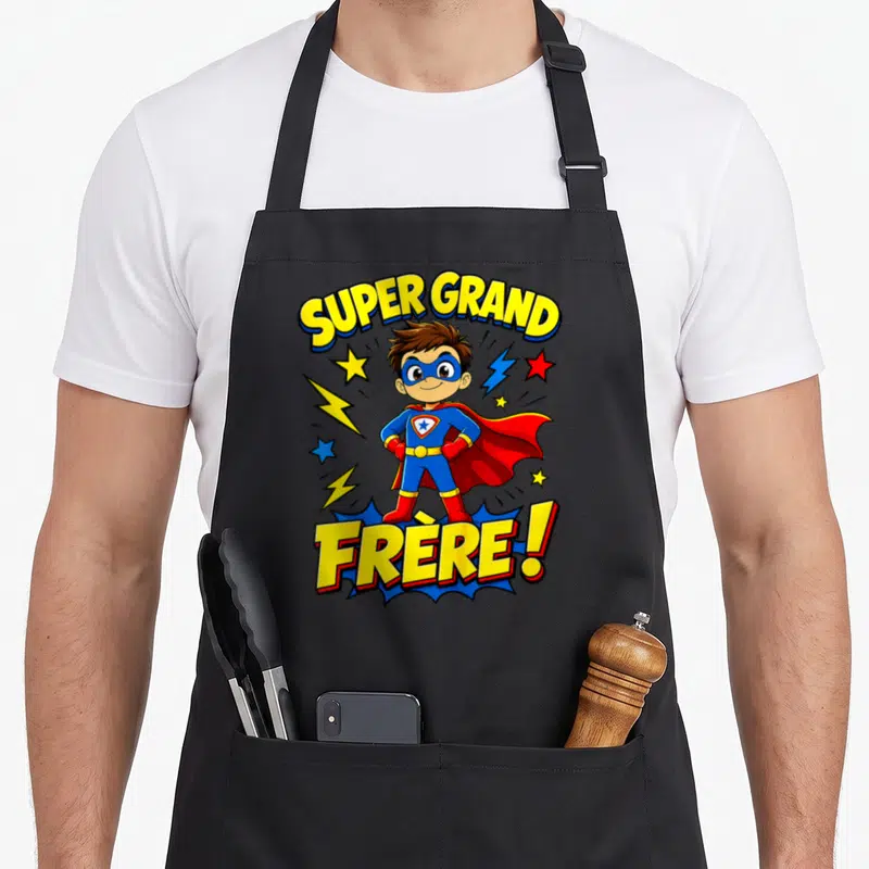 Tablier de cuisine noir avec un super-héros enfant et l'inscription Super Grand Frère en lettres jaunes.