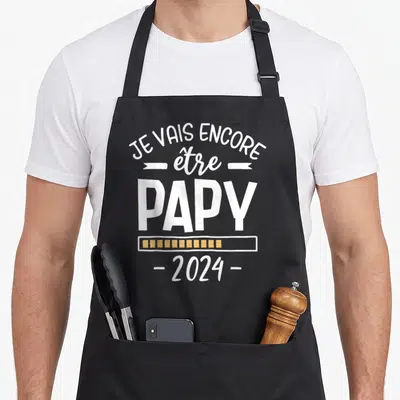 Tablier de cuisine noir avec inscription Je vais encore être papy 2024 et une barre de progression orange.