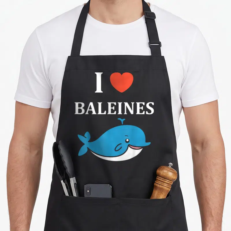 Tablier de cuisine noir avec une baleine bleue souriante, un cœur rouge et le texte I love Baleines en blanc.