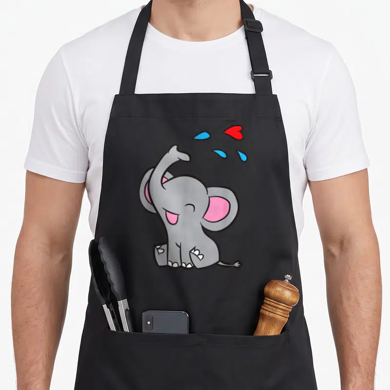Tablier de cuisine noir avec illustration d'un mignon éléphant kawaii gris projetant des gouttes d'eau et un cœur rouge.