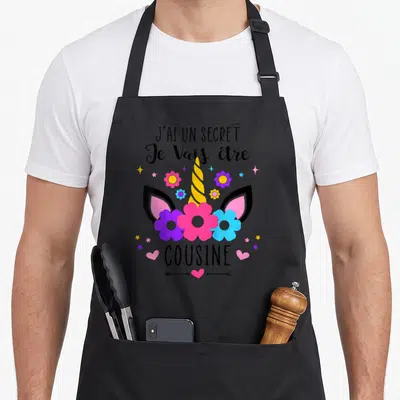 Tablier de cuisine noir avec illustration d'unicorn floral et texte Je Vais être cousine
