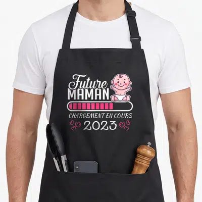 Tablier de cuisine noir avec illustration Future Maman Chargement en cours 2023 et petit bébé souriant en diaper.