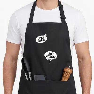 Tablier de cuisine noir avec deux bulles blanches contenant les textes J'ai faim et Moi aussi. en typographie noire.