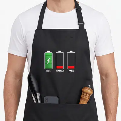 Tablier de cuisine noir avec trois icônes batteries vertes et rouges étiquetées Bébé Maman Papa