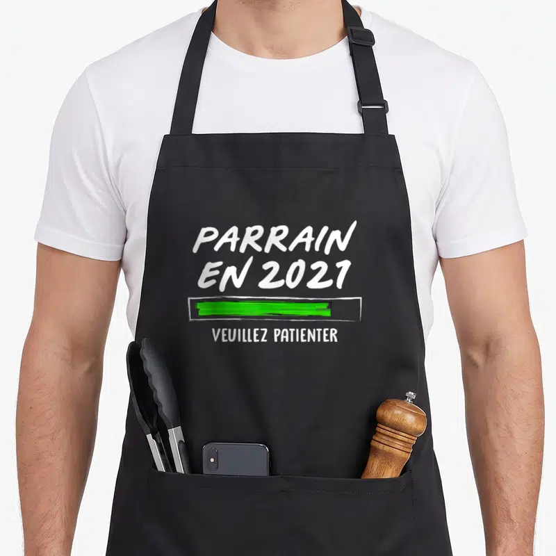 Tablier de cuisine noir avec l'inscription Parrain en 2021 et une barre de chargement verte.