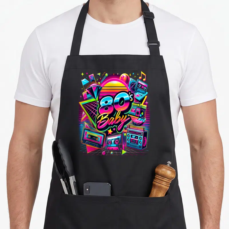 Tablier de cuisine noir avec illustration colorée 80s Baby, cassettes et boombox néon.