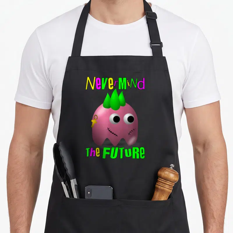 Tablier de cuisine noir avec un petit monstre rose à crête verte et texte Nevermind the Future coloré.